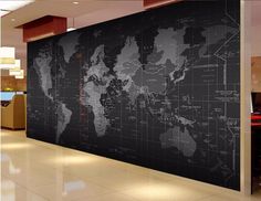 a large black and white world map on the wall