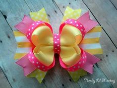 a pink and yellow bow with polka dots