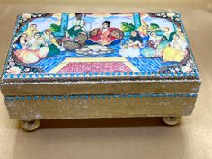 an ornately decorated box sitting on top of a table