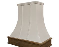 a white range hood on a wooden stand against a white background with the top off