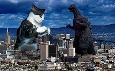 two cats are standing on top of a godzilla and another cat is in the air