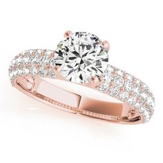 a rose gold engagement ring with diamonds on it