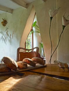 bread on a cutting board in front of a window