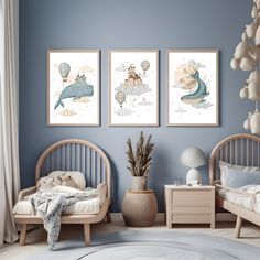 two children's beds in a room with blue walls and artwork on the wall