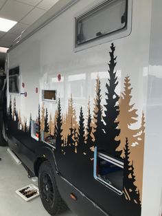 the interior of an rv with trees painted on it