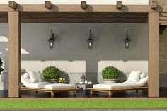 an outdoor living area with two chaise lounges and potted plants