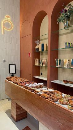 there are many different types of pastries on display in the store, including donuts