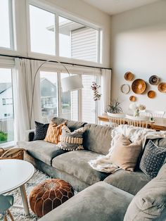 a living room filled with furniture and lots of windows