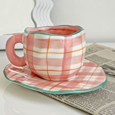 a cup and saucer sitting on top of a table