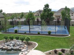 an outdoor basketball court surrounded by landscaping