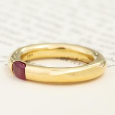 We recently acquired a stack of hefty, gold tubular bands with flush-set gemstones that we’re totally obsessed with! This one centers on a bright raspberry-red ruby, which looks like perfection in yellow gold. Each of these bands feels buttery on the hands, with a delicious weight to boot. A beautiful stacker, but just as gorgeous when worn solo. 18kt yellow gold Size 6.25 and slightly resizable with limitations. Ruby measures 5.4 x 3.84 x 2.83mm, VS2/SI1 type II clarity. GIA standards. Please s Luxury Stackable Ruby Ring With Round Band, Gold Ruby Ring With Polished Round Band, Gold Ruby Ring With Polished Finish, Yellow Gold Ruby Ring With Tension Setting, Luxury Stackable Ruby Ring, Ruby Ring With Polished Finish And Round Band, Yellow Gold Ruby Ring With Polished Finish, Luxury Yellow Gold Ruby Ring With Round Band, Polished Yellow Gold Round Ruby Ring