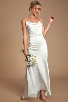 a woman in a white dress holding a bouquet