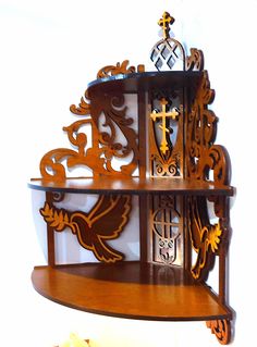 an ornate wooden shelf with crosses on it