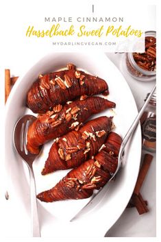 maple cinnamon hasselback sweet potatoes on a white plate with spoons and spices