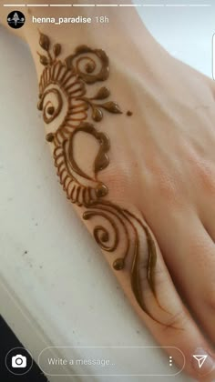 a henna on someone's hand that has been painted with dark brown paint