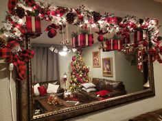 a decorated christmas tree is reflected in a mirror