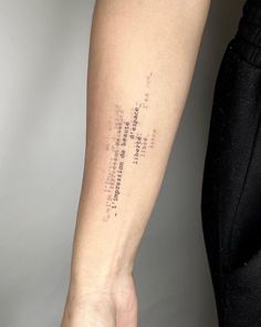 a person with a tattoo on their arm that has words written all over the wrist