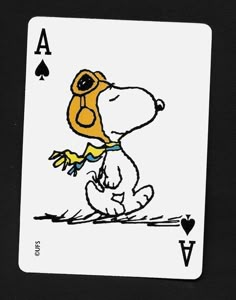 a playing card with a drawing of a dog wearing a hat and holding a tennis racquet