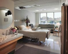 a bathroom with a sink, mirror and couch in the room that is very large