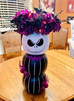 a halloween decoration with purple flowers and lights