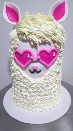 a cake decorated with white frosting and pink heart shaped glasses on top of it