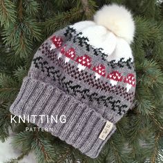 a knitted hat hanging on a tree branch with the words knitting written below it