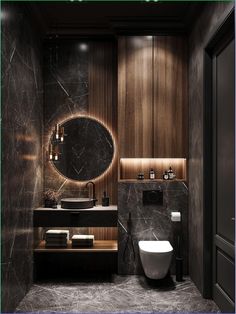 a modern bathroom with marble walls and dark wood accents, including a round mirror above the sink