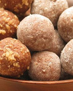 a bowl filled with lots of different types of doughnuts on top of a table