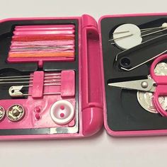 a pink case with scissors and sewing tools in it