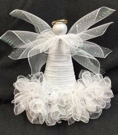 an angel made out of tulle and pearls on top of a black blanket with the caption, what's everyone's thoughts on this?