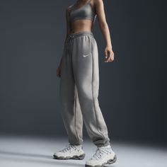 Find NIKE Sportswear Phoenix Fleece High-waisted Oversized Sweatpants on Editorialist. Grounded in style, comfort and versatility, meet our take on luxury loungewear. Whether you're running errands or rewatching your favorite show, these midweight fleece sweats feel extra soft on the inside to help keep you cozy. The oversized fit is intended to sit high on your hips for comfort and a stay-put feel. Benefits:Encased elastic waistband and drawstrings ensure a fit that feels just right. Pockets pr Streetwear Fleece Sweatpants With Elastic Waistband, Urban Style Relaxed Fit Sweats For Sports, Sporty Sweats For Streetwear With Elastic Waistband, Sporty Streetwear Sweats With Elastic Waistband, Athleisure Sweatpants For Streetwear With Relaxed Fit, Streetwear Sportswear Sweatpants With Elastic Waistband, Athleisure Sweats With Elastic Waistband For Streetwear, Athleisure Sweatpants With Ribbed Waistband For Streetwear, Athleisure Sweatpants With Elastic Waistband For Streetwear