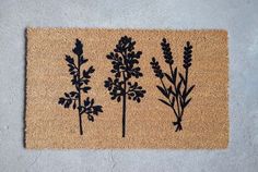 a door mat with three plants on it