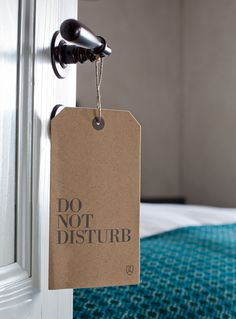 a door hanger with a do not disturb tag hanging from it's side