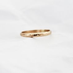 Gold Hammered Band Ring, perfecting for stacking is hand stamped and available in either 14k gold fill or sterling silver!  ∙  Please note that the seam might be visible as the ring is handmade.  ∙ Gift Ready in a jewelry box! ∙ Handmade in Vancouver, Canada.  ∙ 100% 14k Gold Fill or Sterling Silver ∙ Ring Sold Individually --------------------------------- M E A S U R E M E N T :  Width: approx. 2.5mm Size: Optional (US measurement) If your ring size is not specified as an option, please messag Stackable Band Rings For Promise, 14k Gold Band Ring Gift, 14k Gold Band Ring For Gift, 14k Gold Band Ring As Gift, Adjustable 14k Gold Band Rings, Stackable Band Rings As Gift, Minimalist Band Ring For Gifts, Minimalist Band Ring For Gift, Minimalist Band Rings As Gifts