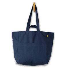 Oversized, easy, multi-pocket tote. Three large exterior pockets + three interior pockets. Comfortable carry straps + short handle straps. Sustainably and ethically handmade in India with 100% GOTS-certified organic cotton. Machine Washable. Cotton Tote Weekender Bag With Pockets, Rectangular Cotton Weekender Bag With Pockets, Cotton Canvas Bag With Silt Pocket For Everyday, Large Bags With Pockets, Large Everyday Bags With Pockets, Daily Use Canvas Tote Bag With Side Pockets, Practical Cotton Bags With Pockets, Everyday Canvas Tote Bag With Flat Pocket, Cotton Tote Bag With Side Pockets