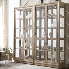 a living room with a couch and a china cabinet