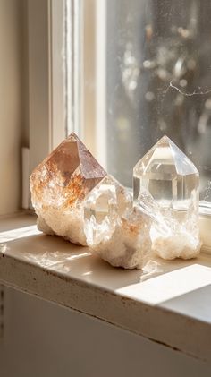 Crystal decor on a bathroom windowsill, featuring small 5-10 cm hexagonal prism crystals in natural colors. Soft beige and brown background, airy aesthetic. No text, photorealism.