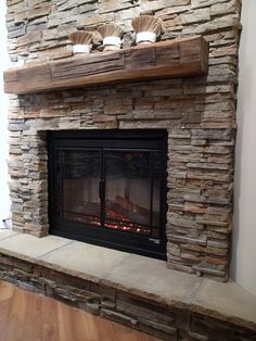 a stone fireplace with two bowls on top