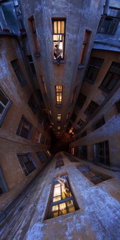 an image of a very tall building taken from the ground looking up at it's windows