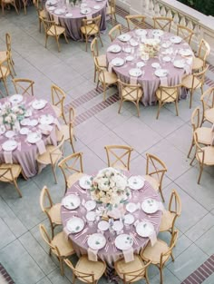 an overhead view of tables and chairs with purple linens