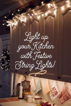 a kitchen with christmas lights hanging from the ceiling and an advertisement on the wall above it