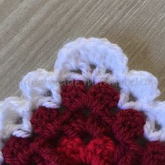 a crocheted red and white object on a table