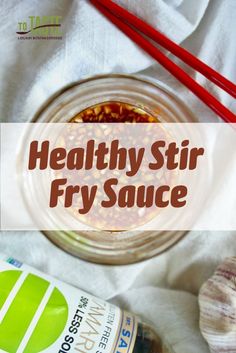 healthy stir fry sauce in a glass jar with red chopsticks on the side