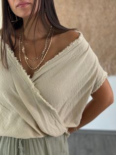 Embrace effortless summer style with our Natural  Sleeve Top. This blouse features distinctive batwing sleeves and a wide, off-shoulder neckline, crafted from soft linen for ultimate comfort. Perfect for both casual and dressy occasions, it adds a touch of bohemian chic to any outfit. A lovely gift for her, this top combines versatility with modern elegance. Key Features ✨ * Material: Soft, breathable organic cotton that offers luxurious comfort while being environmentally friendly. * Size: One Natural Elegant Style, Versatile V-neck Blouse For Beach, Versatile Beige Short Sleeve Blouse, Cotton Wrap Blouse For Beach, Summer Vacation Blouse With Batwing Sleeves, Versatile V-neck Blouse For The Beach, Bohemian Cotton Top With Batwing Sleeves, Bohemian Wrap Top For Day Out, Bohemian Cotton Tops With Batwing Sleeves