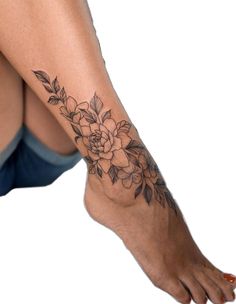 a woman's foot with a flower tattoo on her left side and the bottom part of her leg