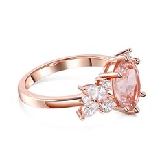 This enchanting piece features a stunning oval-cut morganite as the center stone, radiating beauty and sophistication. Adorning the sides of the main stone are clusters of brilliant white stones, adding a touch of sparkle and enhancing its timeless appeal. Crafted with meticulous attention to detail, this ring captures the essence of refined luxury. The soft, blush-pink hue of the morganite exudes a sense of romance and tenderness, making it a perfect choice for expressing love and devotion. The delicate arrangement of the white stones creates a harmonious balance, accentuating the brilliance of the main stone and illuminating the wearer's hand with a captivating glow. Indulge in the allure of this morganite oval cut ring, a testament to the everlasting beauty of fine jewelry.Carat Weight: Blush Morganite Oval Jewelry, Rose Gold Oval Cluster Ring, Oval Rose Gold Crystal Ring With Accent Stones, Oval Rose Gold Cluster Ring, Expressing Love, Oval Cut Ring, Divine Love, White Stones, White Stone