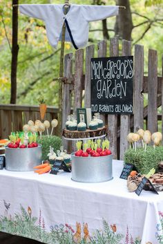 a table topped with cakes and cupcakes on top of a white table cloth