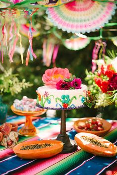 a table topped with lots of cakes and desserts