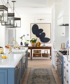 a kitchen with blue cabinets and an area rug on the floor in front of it