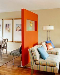 a living room filled with furniture and pictures on the wall